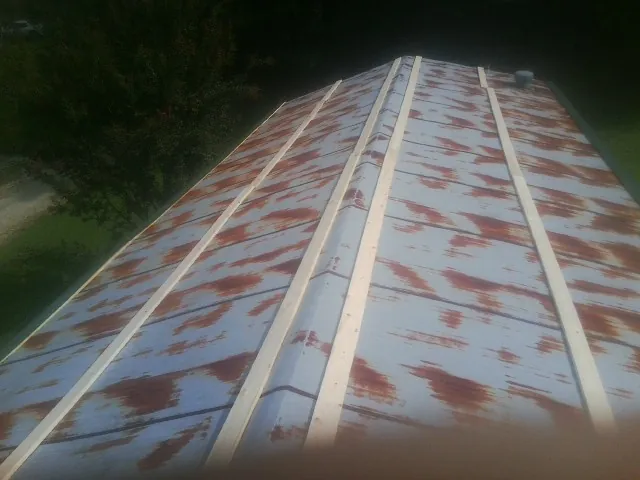 Rusted metal roof panels with new wood purlins before replacement — Storm Damage Roof Repair in Glen Gardner by Roofing Brothers
