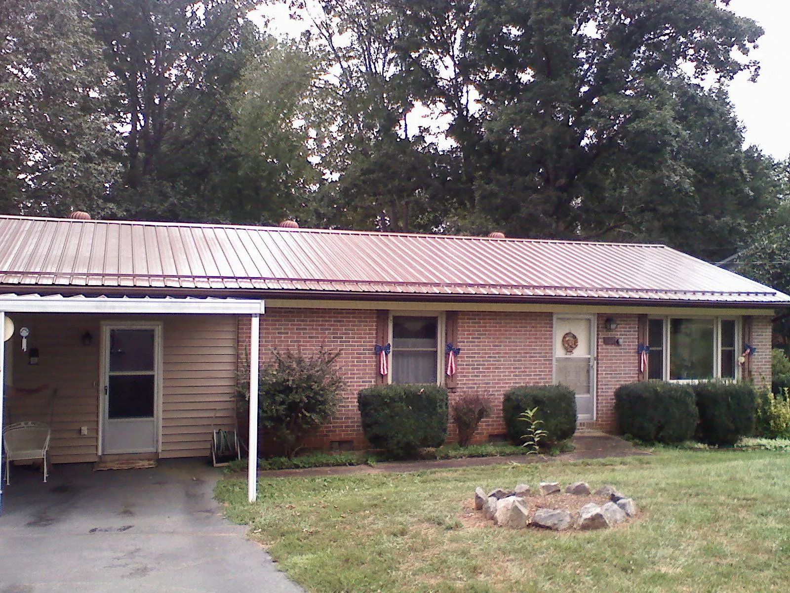 Bronze metal roof and carport on a brick ranch home — Roof Repair work by our crew in Glen Gardner